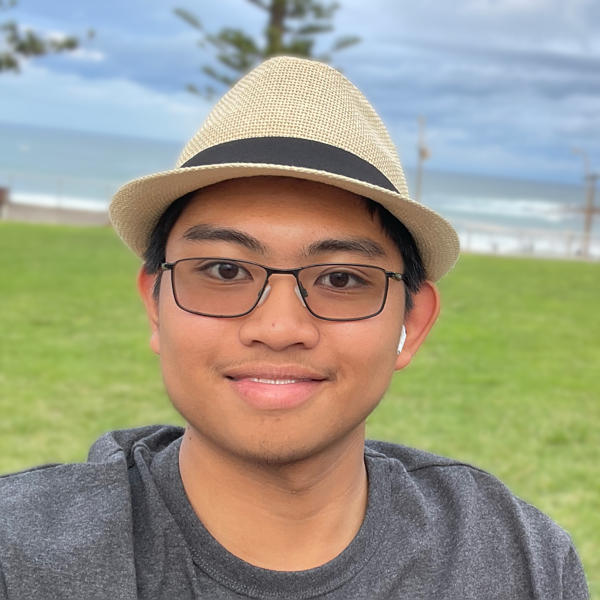 A picture of kElna at the beach, smiling into the camera.